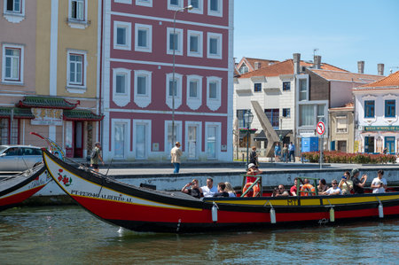Aveiro, Portugal. 2022 May 12 . Traditional boats in the canal of Aveiro, Portugal. The colorful Moliceiro de Aveiro boat tours are popular with tourists to enjoy views of the charming canals. Aveiro, Portugal.のeditorial素材