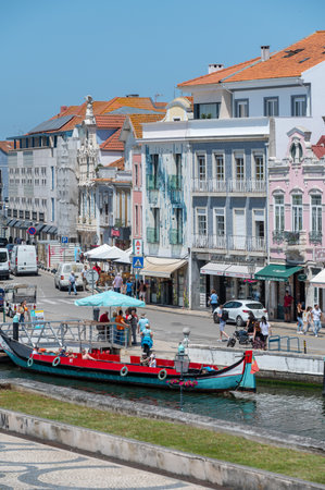 Aveiro, Portugal. 2022 May 12 . Traditional boats in the canal of Aveiro, Portugal. The colorful Moliceiro de Aveiro boat tours are popular with tourists to enjoy views of the charming canals. Aveiro, Portugal.のeditorial素材