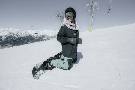 Portrait of a young woman snowboarder on the pisteの写真素材