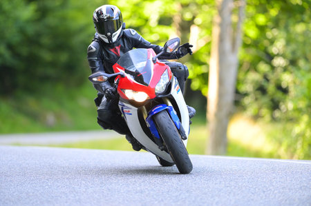 Col du Portillon, France : 2024 July 20 : Biker on his motorcycle on the road on the Col du...