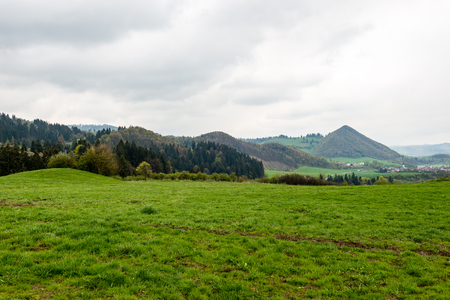 colorful countryside view in carpathians. mountains and forest trees with green meadowsの写真素材