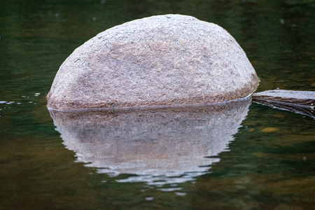 reflection of the rock on the waterの写真素材