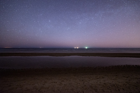 night sky with stars on the summer beach. space view from earthの写真素材