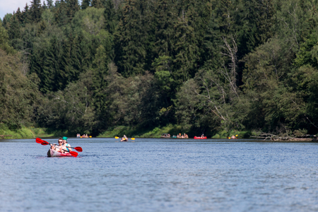 tourists enjoying water sports, kayaking in wild river - Sigulda, Latviaのeditorial素材