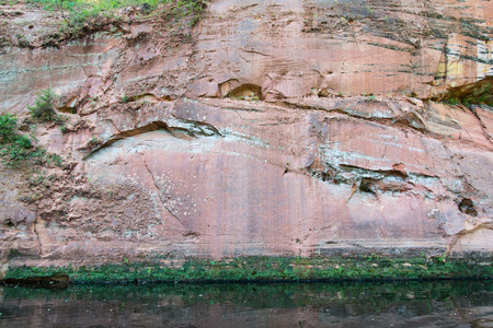 sandstone cliffs on the river shore in the Gaujas National Park, Latviaの写真素材