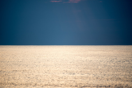 calm sea with waves before sunsetの写真素材
