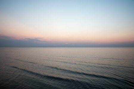 colorful sunset in the sea with reflections and cloudsの写真素材