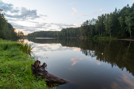 river with reflections in weater and sandstone cliffs in latviaの写真素材