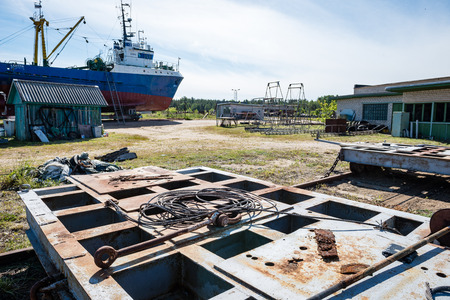 cargo ship is leaving port sailing away. riga. latviaの写真素材