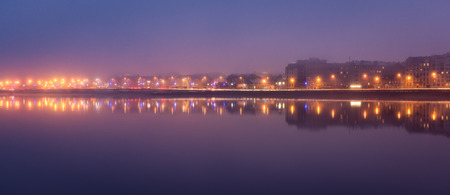 colorful Night skyline on the river with reflection in Riga, Latvia
