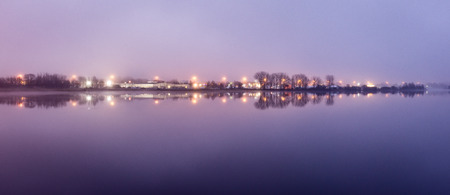 colorful Night skyline on the river with reflection in Riga, Latviaの写真素材