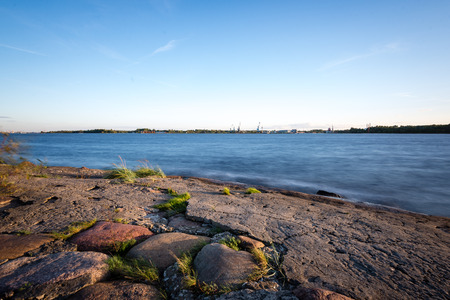 calm river at countryside with green meadow and blue skyの写真素材