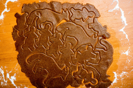 Making Gingerbread Cookies Series. Preparing and cutting dough sheet into shapes.