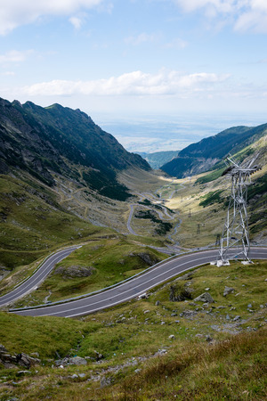 View to the carpathian mountains war road transfagarasan from the top with lonely trees and clouds aboveの写真素材