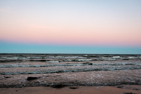 rocky sea beach with wide angle perspective over the sea clouds