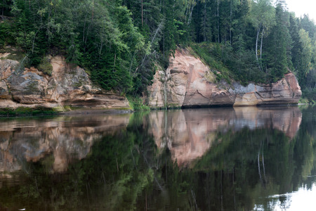 sandstone cliffs on the river shore in the Gaujas National Park, Latviaの写真素材