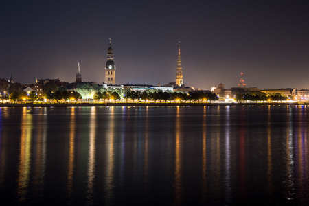 city light reflections over water at the nightの写真素材