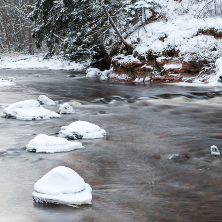 Frozen winter river landscape with ice and snow