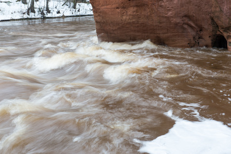 scenic winter colored river in country with snow and treesの写真素材