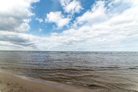 White clouds on the blue sky over country beachの写真素材