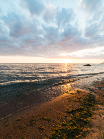 red and orange dramatic sunset on the sea beach with colorful skyの写真素材