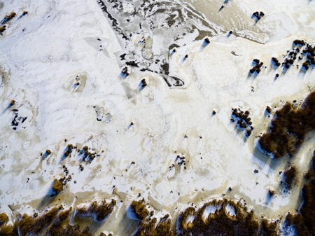 aerial view of frozen forest lake in winter. drone photography. abstract textureの写真素材