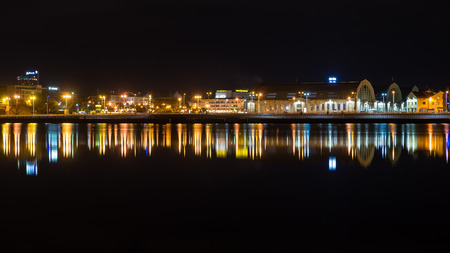 night city reflections in river, Riga, Latviaの写真素材