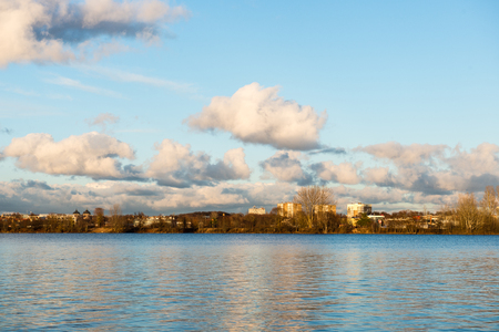 White clouds over the river with blue sky and city skylineの写真素材