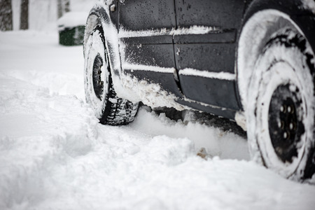 offroad car tires stuck in the snow in cold winterの写真素材
