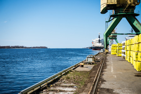 old crane with rusty metal rails near sea port.のeditorial素材