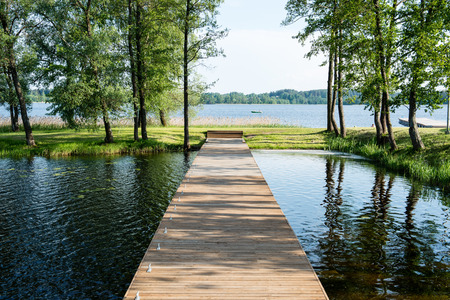 old bridge in forest seen in perspective. central compositionの写真素材