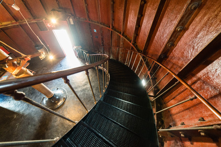 A spiral staircase inside a old wooden lighthouse.の写真素材