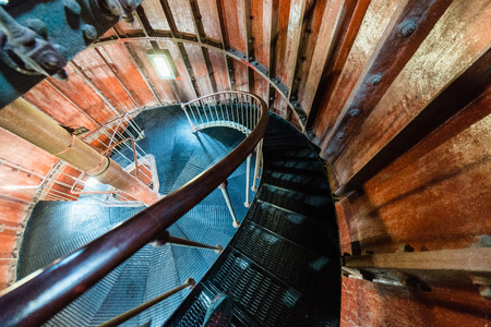 A spiral staircase inside a old wooden lighthouse.の写真素材
