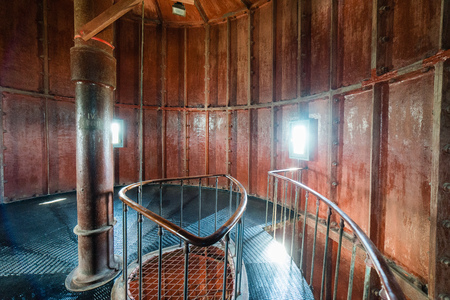 A spiral staircase inside a old wooden lighthouse.の写真素材
