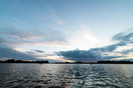colorful orange sunrise over the lake in summerの写真素材