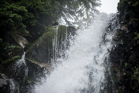 Waterfall splashes in closeup. abstract texture of water with bubbles