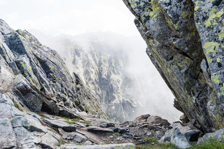 rocky mountain landscape covered with clouds and fog. High Tatra, Slovakia