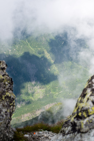 rocky mountain landscape covered with clouds and fog. High Tatra, Slovakiaの写真素材