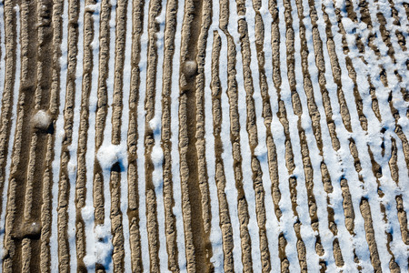 frozen sand with ice blocks. abstract texture in natural beachの写真素材