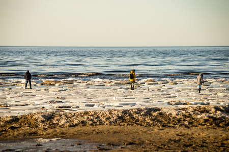 people enjoying frozen beach in winters cold. walking and relaxingの写真素材
