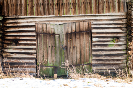 frozen countryside scene in winter with snow. cottage with shedの写真素材