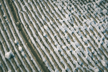 frozen sand with ice blocks. abstract texture in natural beachの写真素材