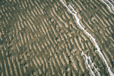 frozen sand with ice blocks. abstract texture in natural beach