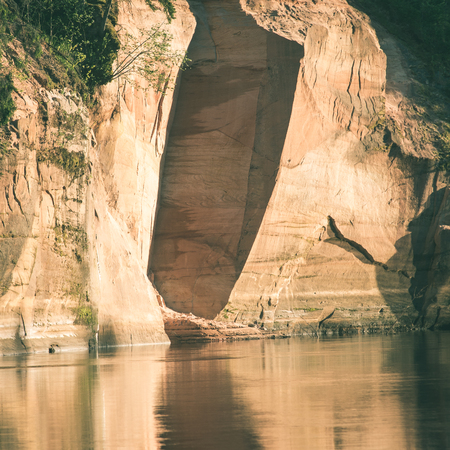 sandstone cliffs by the river in Gauja national park in latvia - instant vintage square photoの写真素材