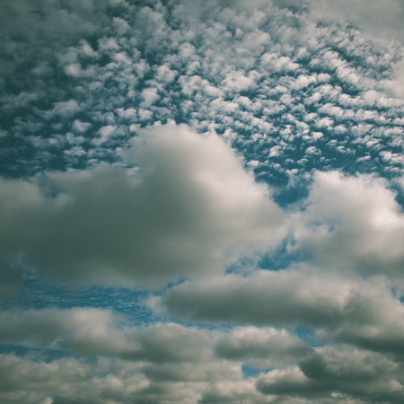 Country landscape under morning sky with clouds. Overcast sky before storm. - instant vintage square photoの写真素材