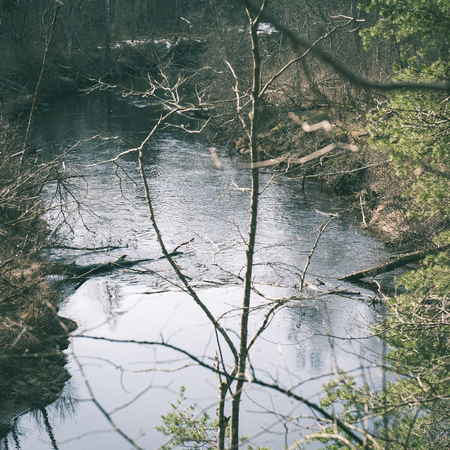 scenic spring colored river in country with trees and reflections - instant vintage square photo