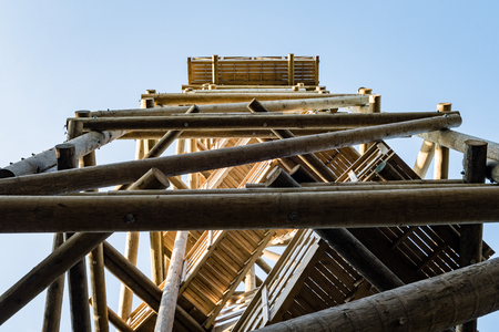 details of wooden watch tower deep in country forest with metal boltsの写真素材