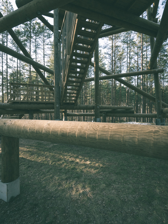 details of wooden watch tower deep in country forest with metal bolts - vintage green retro effectの写真素材