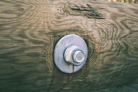 details of wooden watch tower deep in country forest with metal bolts - vintage green retro effectの写真素材