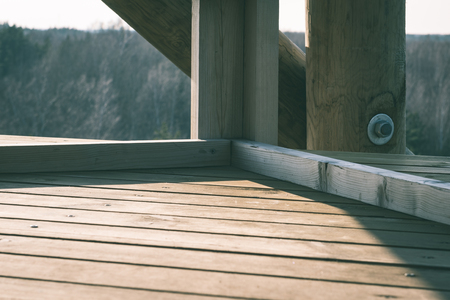 details of wooden watch tower deep in country forest with metal bolts - vintage green retro effectの写真素材